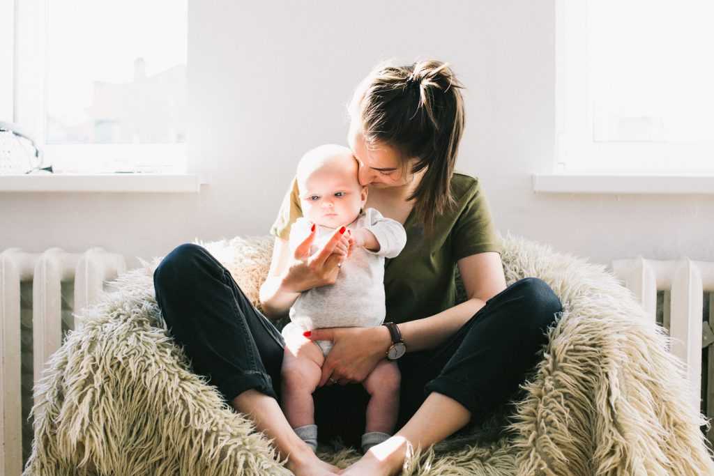 mother holding small baby in her lap