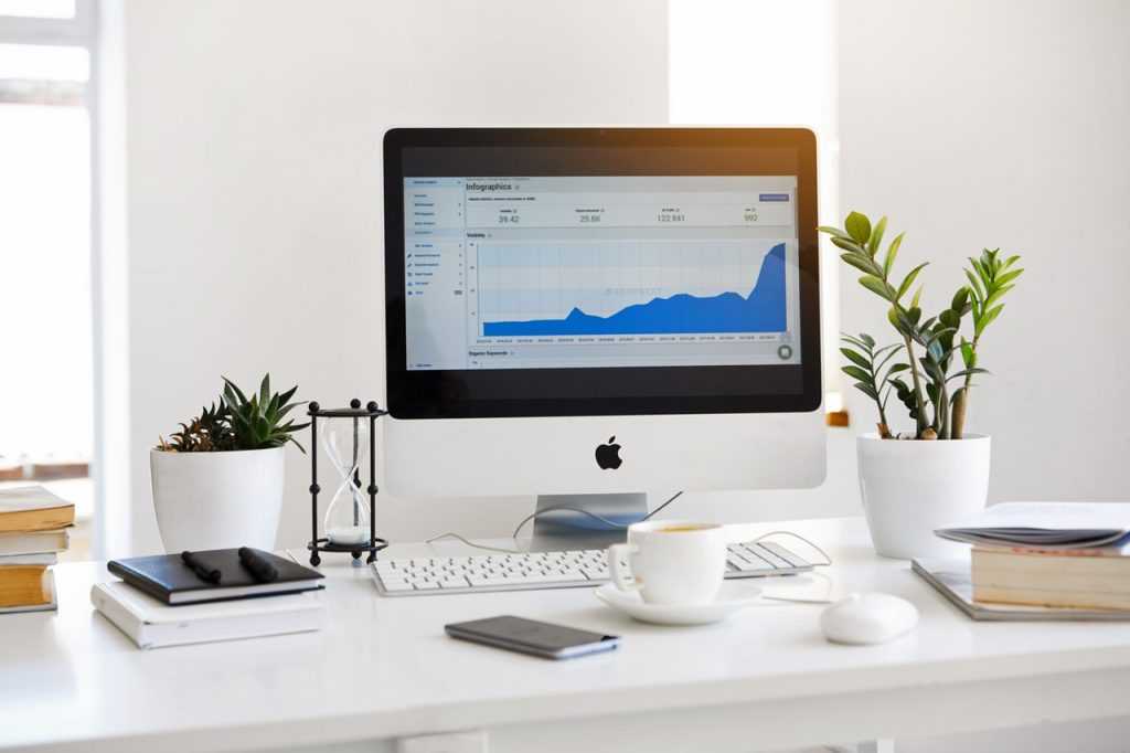 computer sitting on a desk with a report on the screen